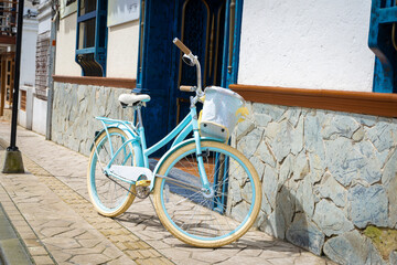 Old bicycle on the street on the wall