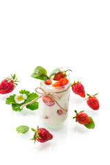 sweet homemade yogurt with ripe fresh strawberries in a jar