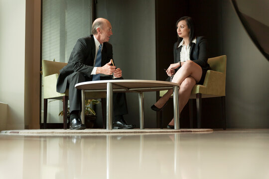 A male and female executive impromptu meeting