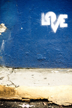 Graffiti Of The Word Love On A Bright Blue Wall