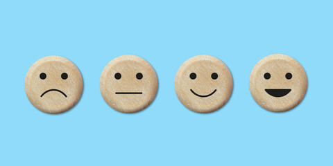Wooden web buttons with facial expressions negative, neutral, positive and very happy . Customer service experience and satisfaction survey concept . Feedback icons for client
