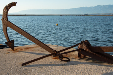 Rusty old anchor on the waterfront in Nin, Croatia, on the Adriatic sea