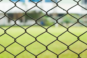 Fototapeta premium Close up link fence and blur garden on back texture and backgroun