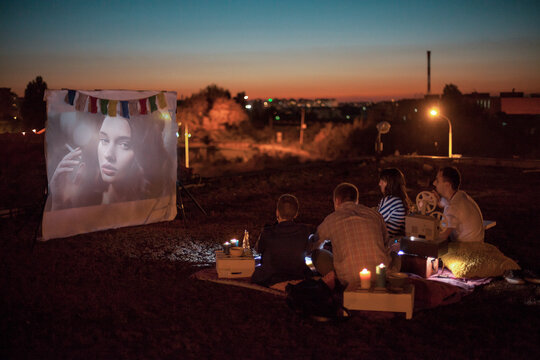 Friends Watching a Movie in Open Air Cinema