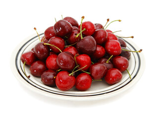 Dish with ripe cherries. Isolated on a white background. .