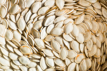 Pumpkin seeds ready to be roasted, rinsing off in a bowl of water