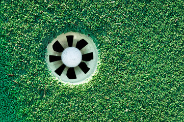 overhead view of a golf ball in the hole