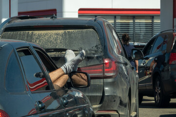 The passenger stretched his sock-clad legs out of the car window. Selective focus.