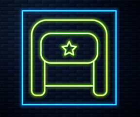 Glowing neon line Ushanka icon isolated on brick wall background. Russian fur winter hat ushanka with star. Soviet Union uniform of KGB and NKVD. Vector.