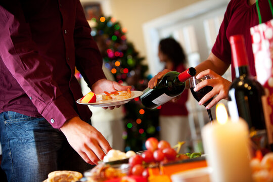 Christmas: Party Guest Pouring Wine