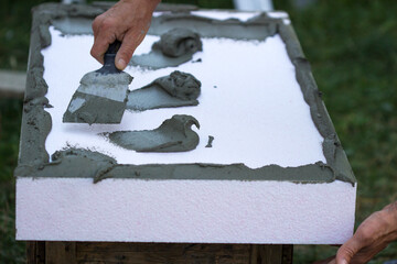 Wall insulation with polystyrene panels, glue application and installation.
