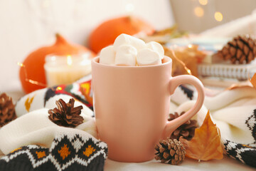 Fototapeta na wymiar Autumn concept with cup of coffee with marshmallow and sweater