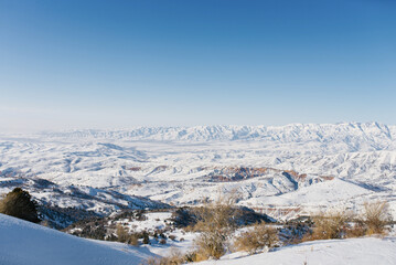 Panoramic view of the mountains with rocks in the Tien Shan mountains in Central Asia near Tashkent on a Sunny winter day. The best view from the Beldersay cable-way
