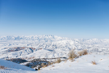 Fototapeta na wymiar Picturesque Tien Shan mountains in Uzbekistan, covered with snow, winter clear Sunny day in the mountains