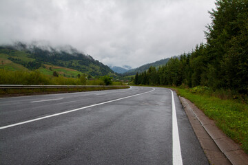 Highway through the Carpathian mountains on a cloudy rainy day