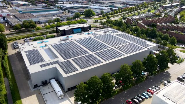 Jib Down Of Large Building On Industrial Terrain With A Lot Of Solar Panels On Roof