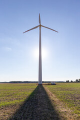 Fototapeta na wymiar Wind turbine under blue sky at sunset, renewable energy concept photo