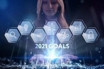 Business, Technology, Internet and network concept. Young businessman working on a virtual screen of the future and sees the inscription: 2021 goals