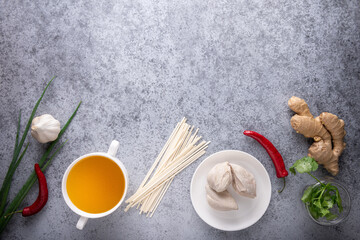 Spicy asian soup ingredients on gray background