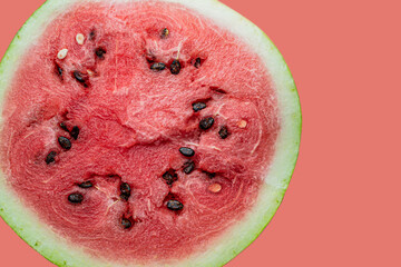 ripe watermelon with black seeds on red background