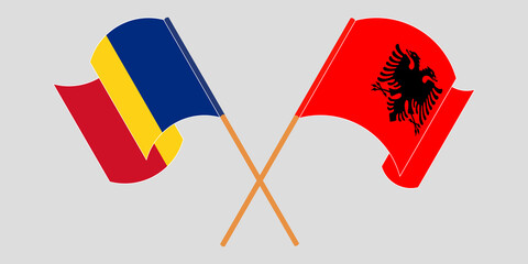 Crossed and waving flags of Albania and Romania