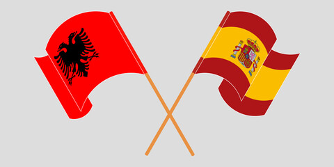Crossed and waving flags of Albania and Spain