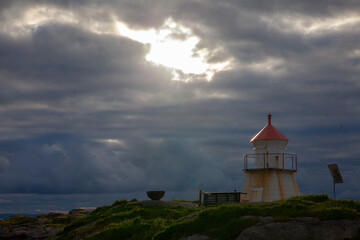 Fototapeta na wymiar small lighthouse in a wild and barren coastal landscape