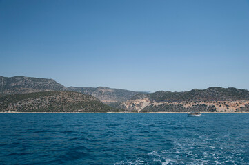 Fototapeta na wymiar Beautiful sea rocky coast and yacht or boat.