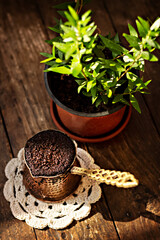 cezve with coffee on wooden background