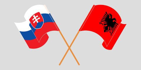 Crossed and waving flags of Albania and Slovakia