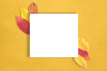 Fototapeta premium Autumn composition. Paper billet, dry leaves on a yellow background. Flat sunbed, top view, space for copying.