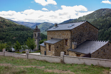 image of the parish church san martin de los oscos with a background of mountains and clouds
