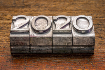 2020 year in vintage, gritty letterpress metal type against rustic, weathered wood