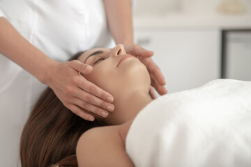 Obraz na płótnie Canvas Professional doing face massage to a customer