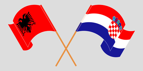 Crossed and waving flags of Albania and Croatia