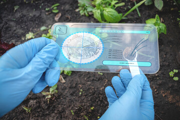 A scientist analysing soil dirt by digital sci fi digital scanner.