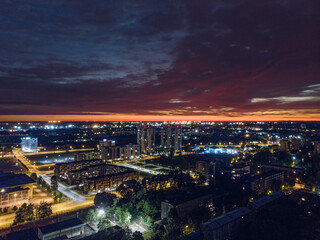 Midnight aerial view of Riga city skyline with crack of light on horizon