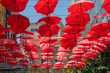 Red Umbrellas Hanging Street © markobe