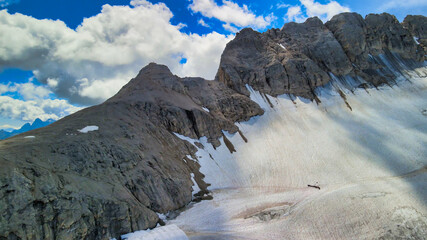 Aerial view of Marmolada Glacier from drone in summer season, Dolomite Mountains