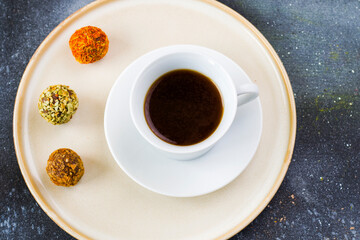 Coffee espresso and truffles balls on the plate