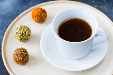 Coffee espresso and truffles balls on the plate