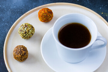 Coffee espresso and truffles balls on the plate