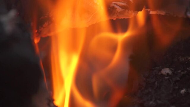 Close up fire flame of marching fire, slow motion of burning wood. Bright bonfire with beautiful sparks. Campfire b-roll footage