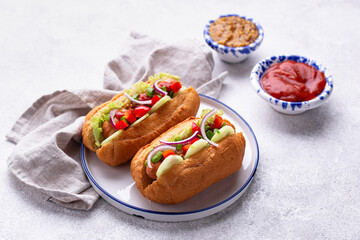 Hot dogs with sausage, sauces and vegetables