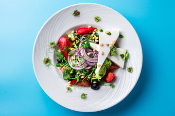 Greek salad on a blue background