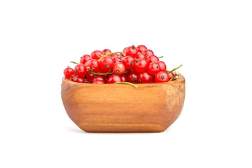 Wooden bowl with red currant berries isolated on white