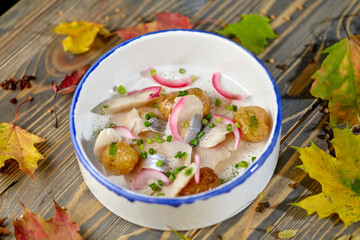 Baked mini potatoes with salted or smoked fish are on the plate.