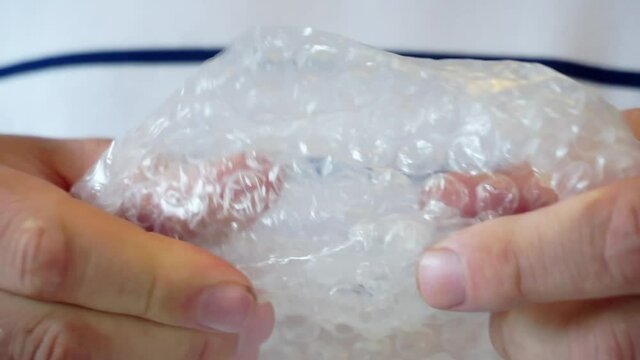 man is stressful and tearing bubble film.