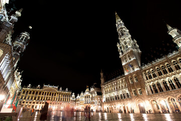 Fototapeta na wymiar Panoramic night view of grand place of Brussels ( Belgium ) during rain. Long time exposure. The grand palace on the right. its Baroque style is part of UNESCO world heritage