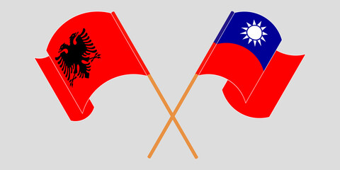 Crossed and waving flags of Albania and Taiwan